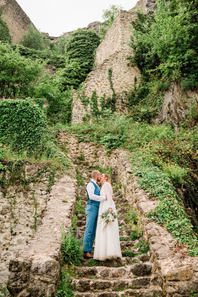 newlyweds infront old building kissing