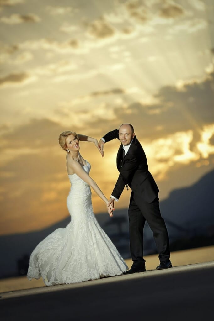 newlyweds making heart with hands